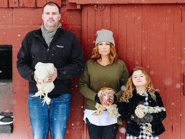 The Hughes family with their pet chickens.