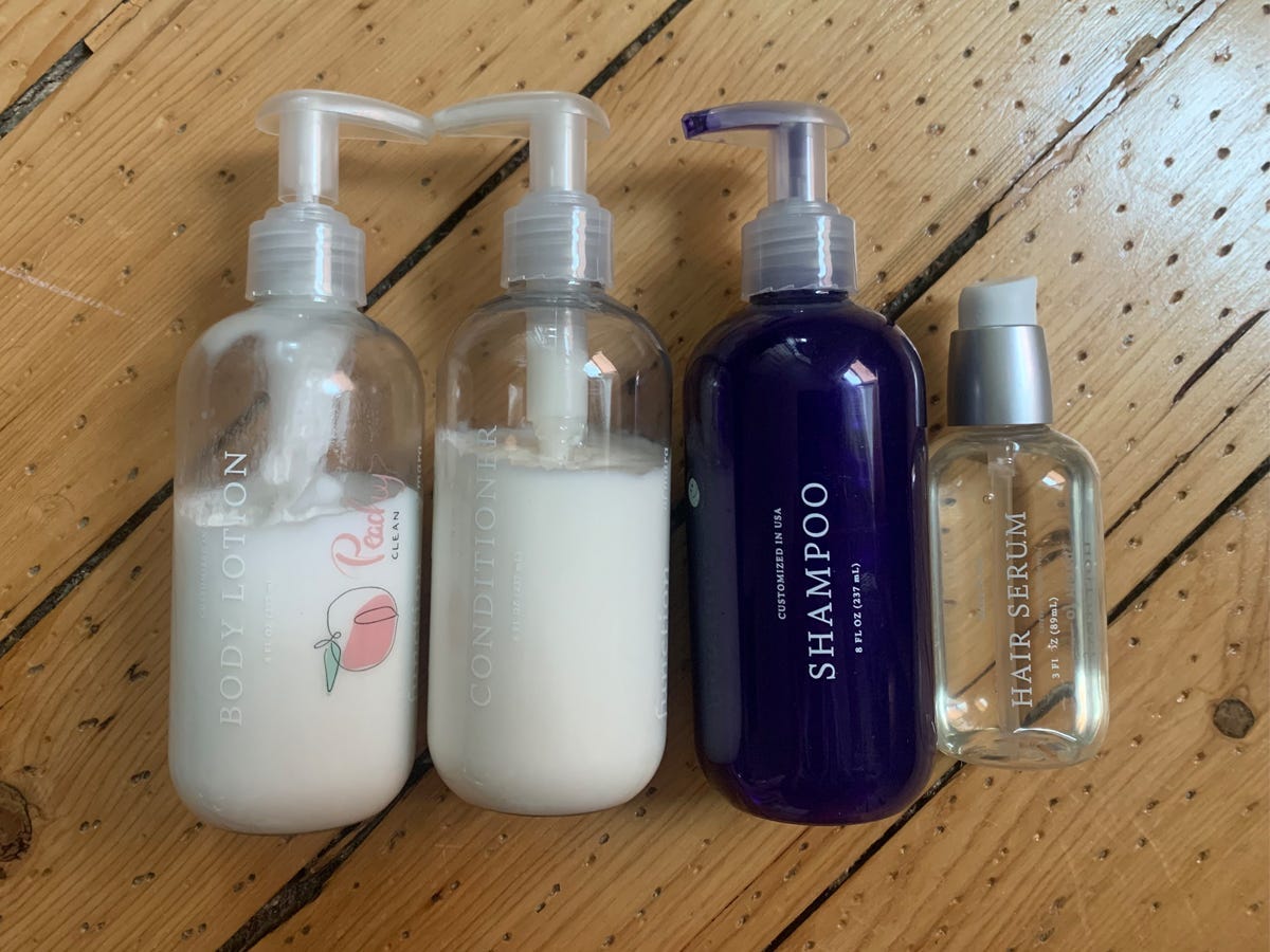 Mara's custom Function of Beauty lineup includes: a purple shampoo, white conditioner, hair serum, and body lotion.