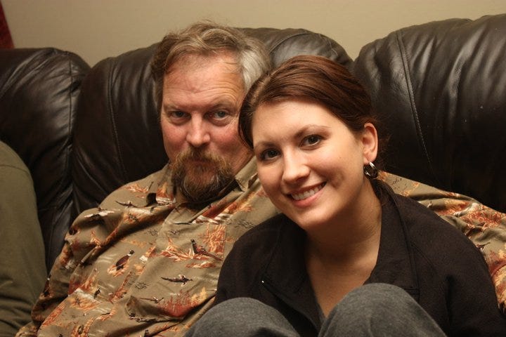 writer shanna goodman sits on the couch with her dad