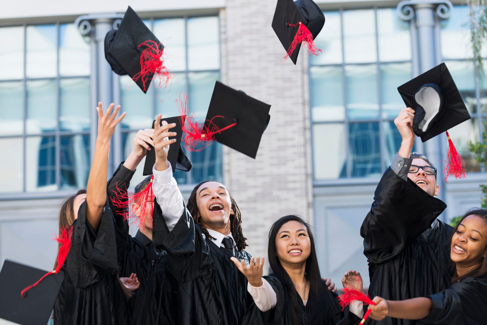 Graduates throwing caps in the air.