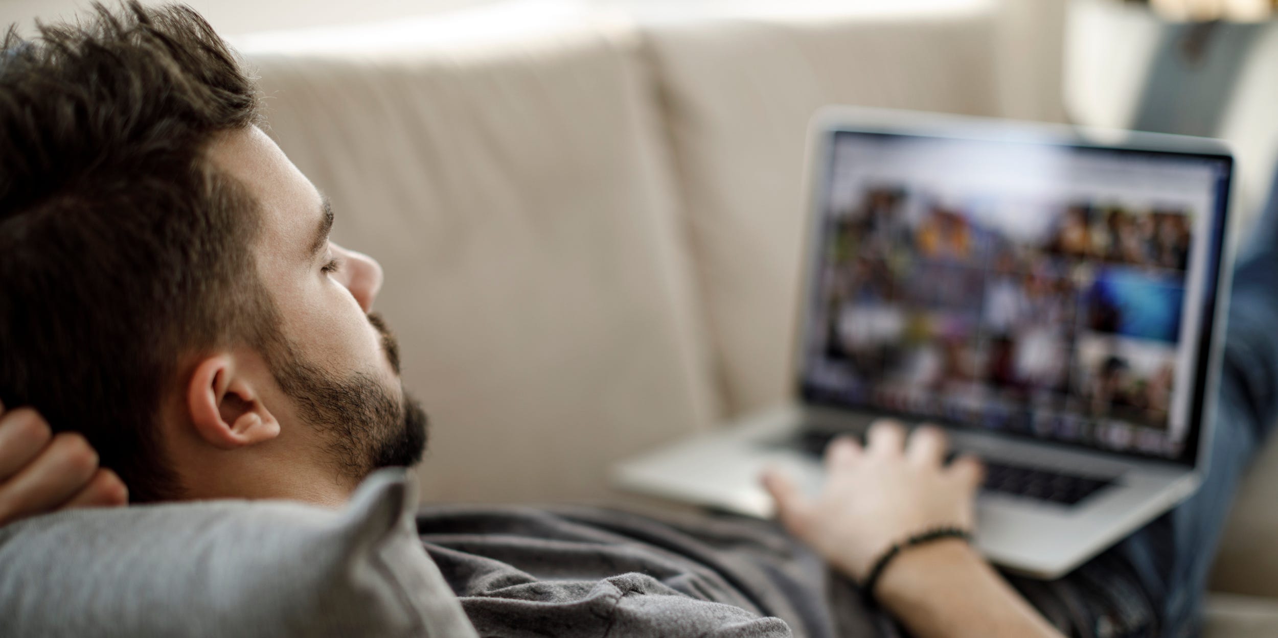 man using laptop watching shows