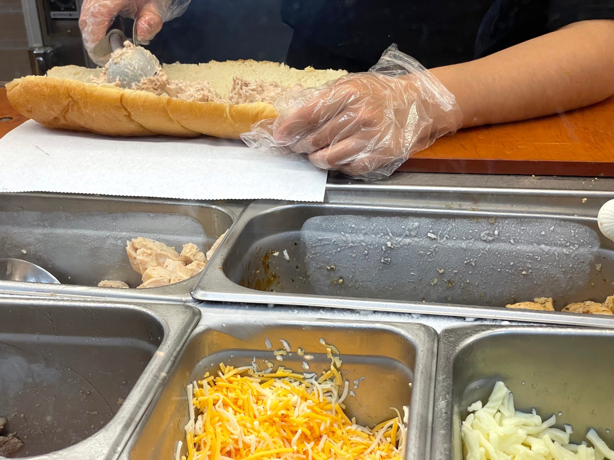 Subway worker making tuna sandwich