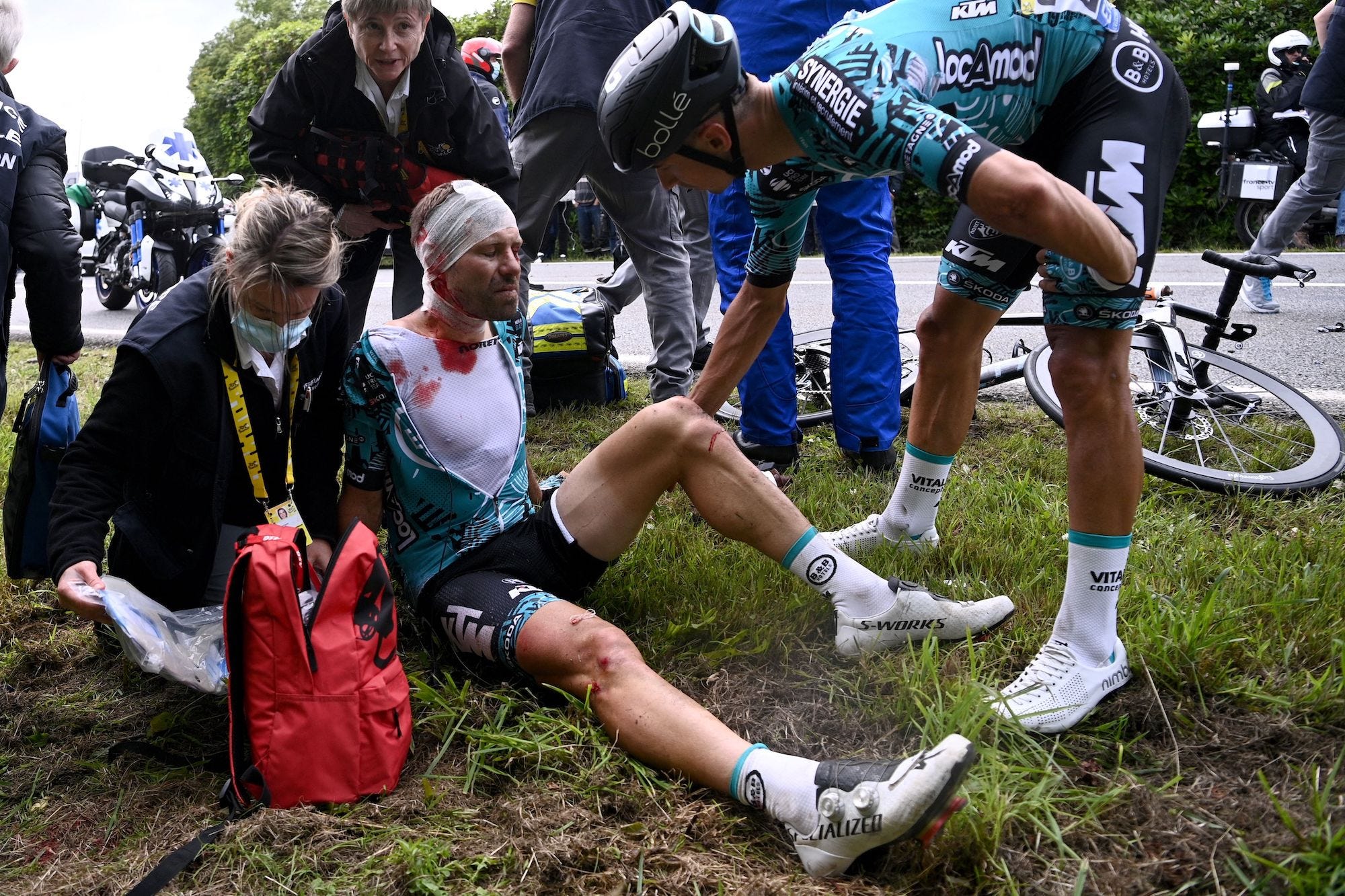 Team B&B KTM's Cyril Lemoine of France is helped by medical staff after crashing during the first stage of the 108th edition of the Tour.