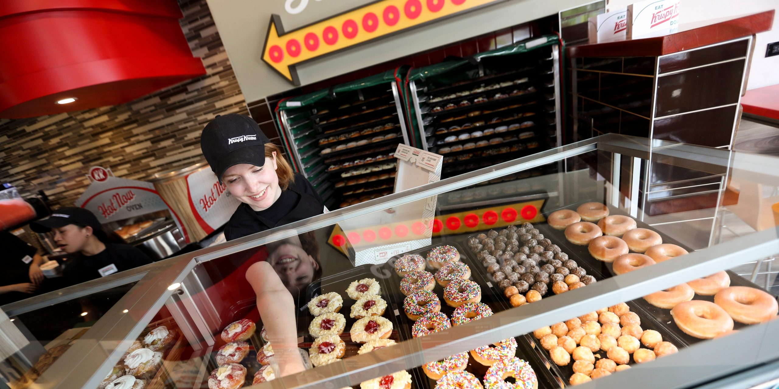 A Krew member at a Krispy Kreme store in Toronto, Ontario, loads up a box of doughnuts.