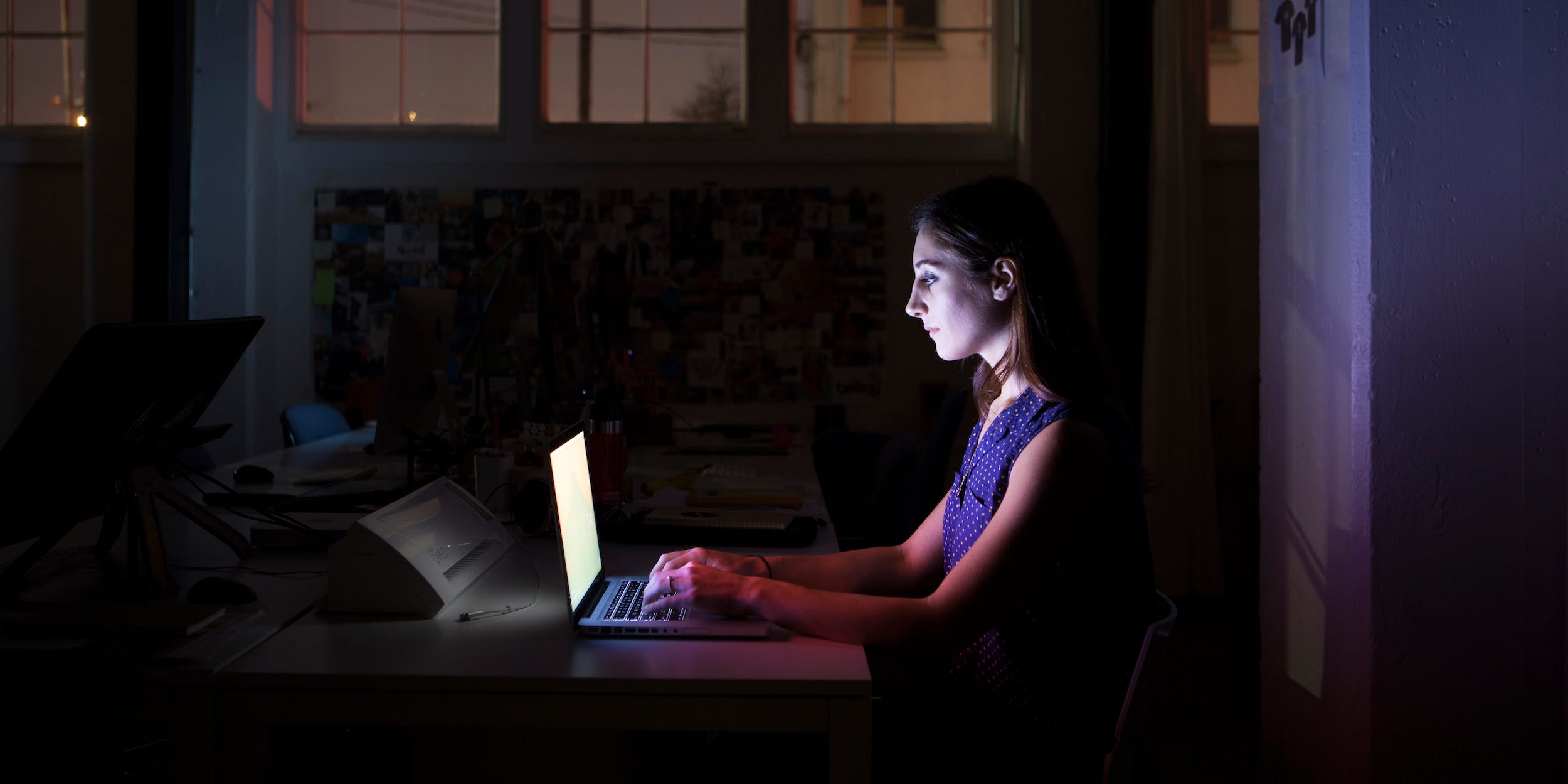 young person using laptop at home at night