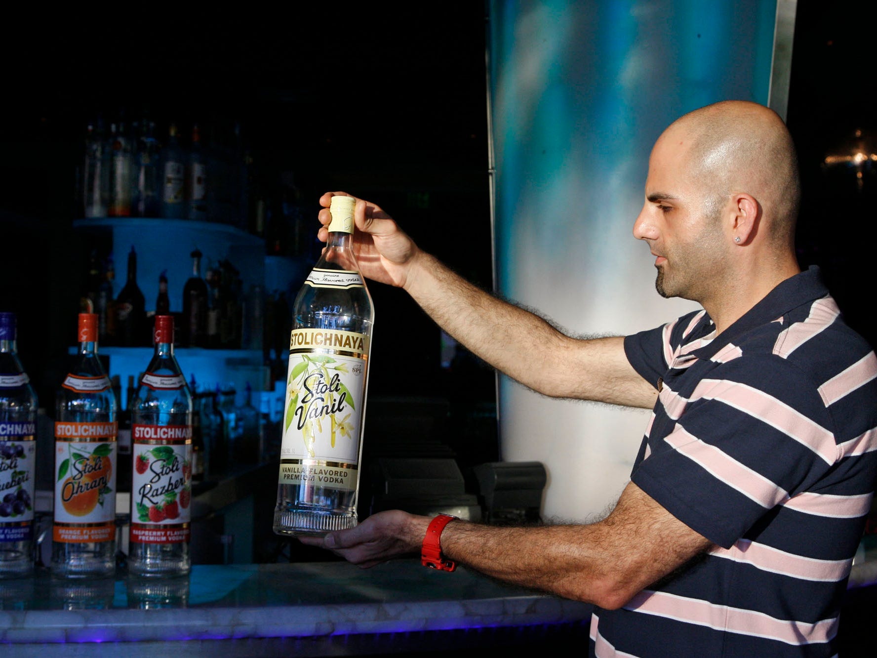 man holding 3-liter bottle of alcohol